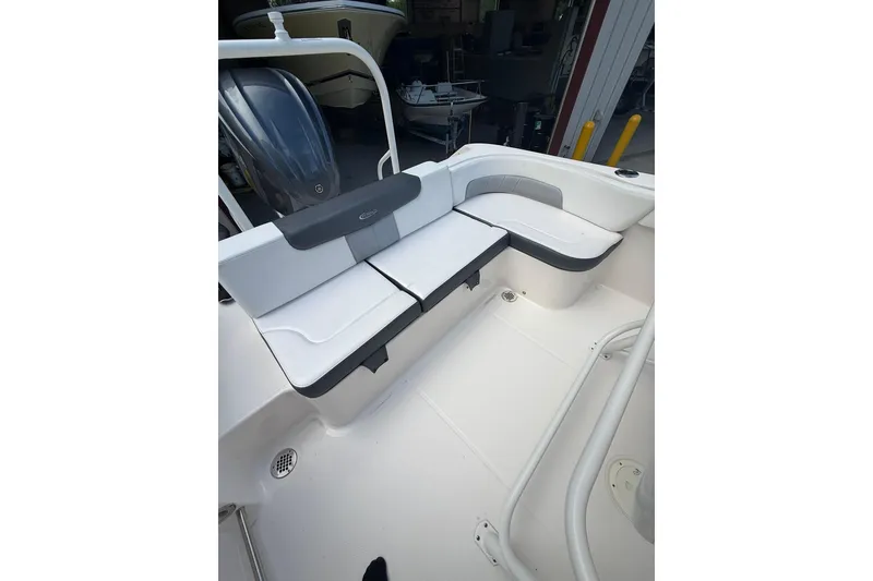 Slide: The Image of 2022 Robalo R200 Center Console boat with white seating and sleek design. - 1