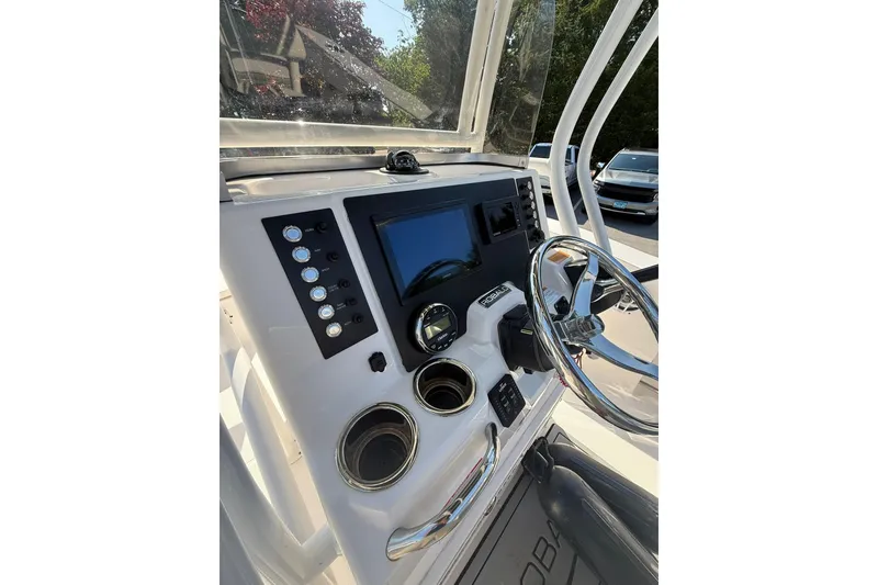 Slide: The Image of 2022 Robalo R200 Center Console boat dashboard with steering wheel and controls. - 13