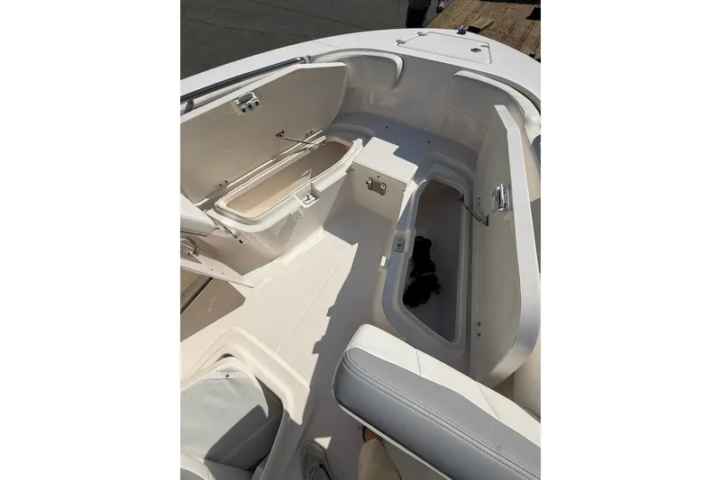 Slide: The Image of 2022 Robalo R200 Center Console boat interior with open storage compartments. - 21