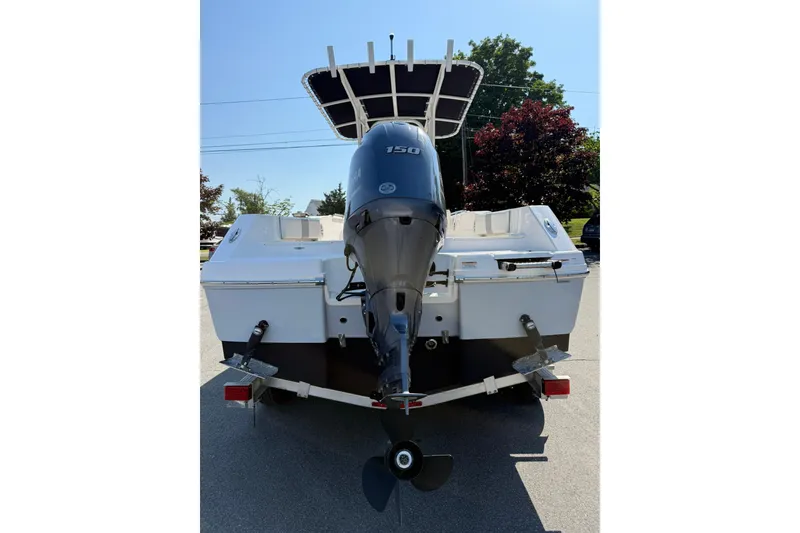 Slide: The Image of 2022 Robalo R200 Center Console boat with outboard motor, parked on a trailer. - 2