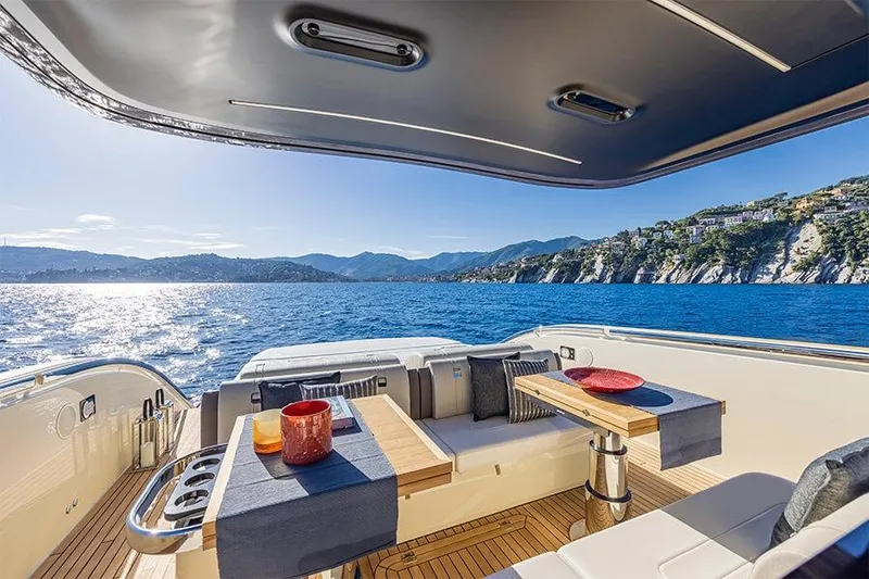 Slide: The Image of Luxurious Invictus 470 yacht interior with ocean view, 2025 model, featuring elegant seating and table. - 4