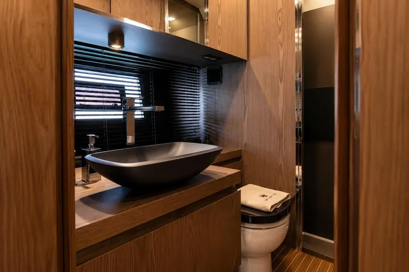 Slide: The Image of Luxurious bathroom interior of 2025 Invictus 470 yacht with modern sink and wooden cabinetry. - 8