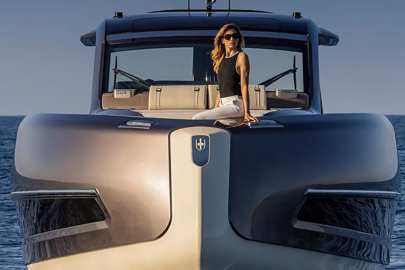 Slide: The Image of Woman sitting on the bow of a 2025 Invictus 470 yacht at sea. - 3