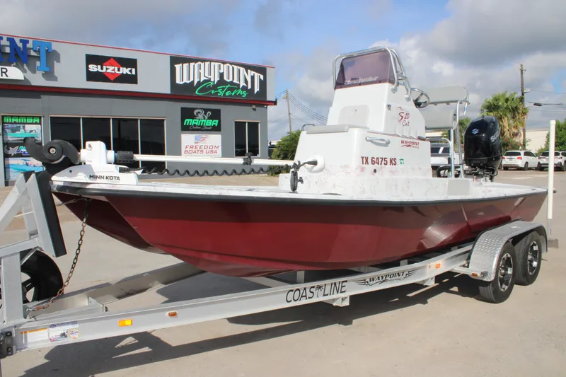 Slide: The Image of 2022 Shoalwater 20' Catamaran on trailer outside dealership, featuring Minn Kota motor. - 3