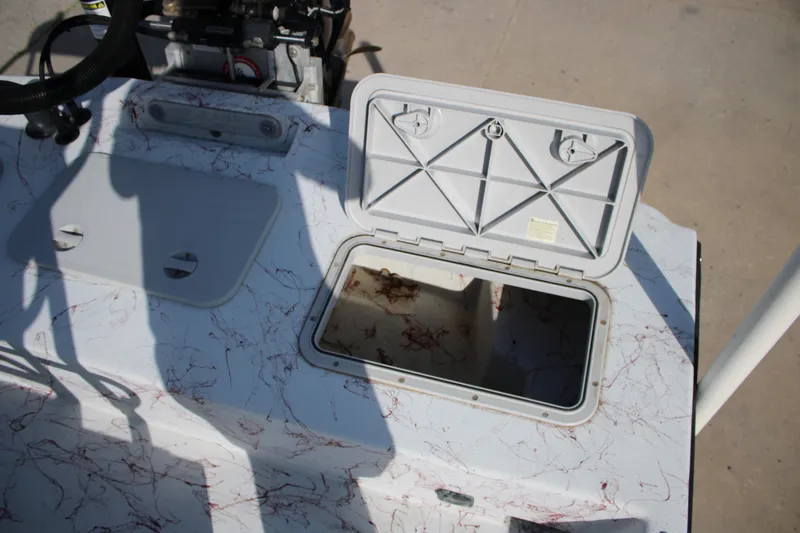 Slide: The Image of Open storage compartment on a 2022 Shoalwater 20' Catamaran boat deck. - 14