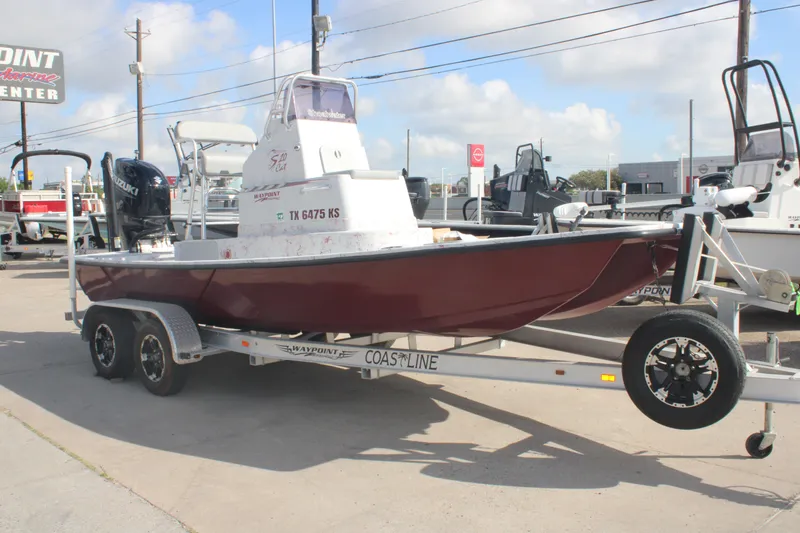 The Image of 2022 Shoalwater 20' Catamaran on trailer, displayed outdoors at a marine center. - 0