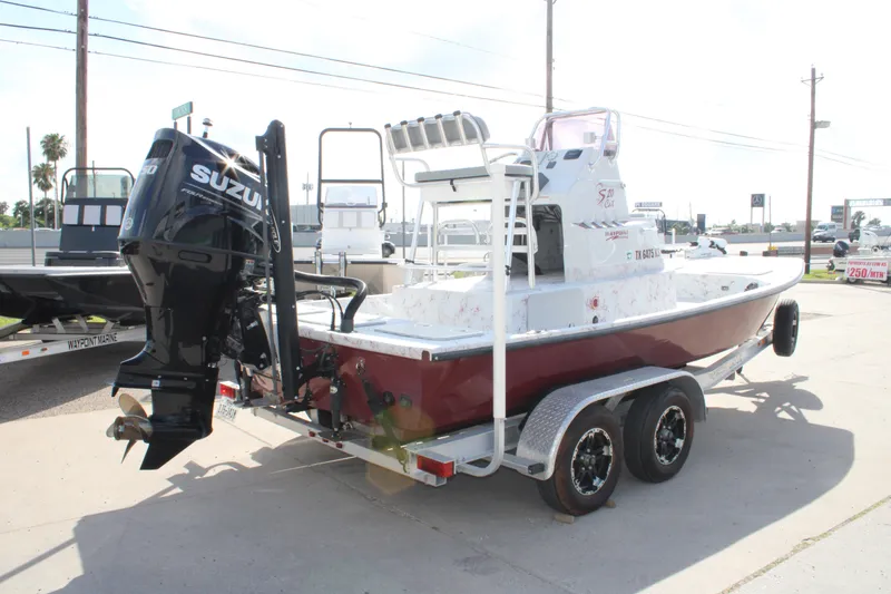 Slide: The Image of 2022 Shoalwater 20' Catamaran with Suzuki outboard motor on trailer. - 17