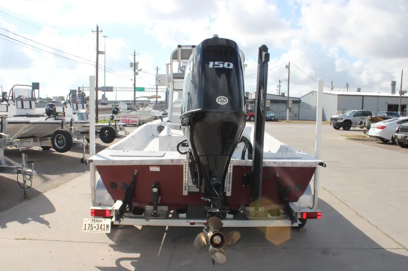 Slide: The Image of 2022 Shoalwater 20' Catamaran with 150 HP engine, parked on a trailer. - 4