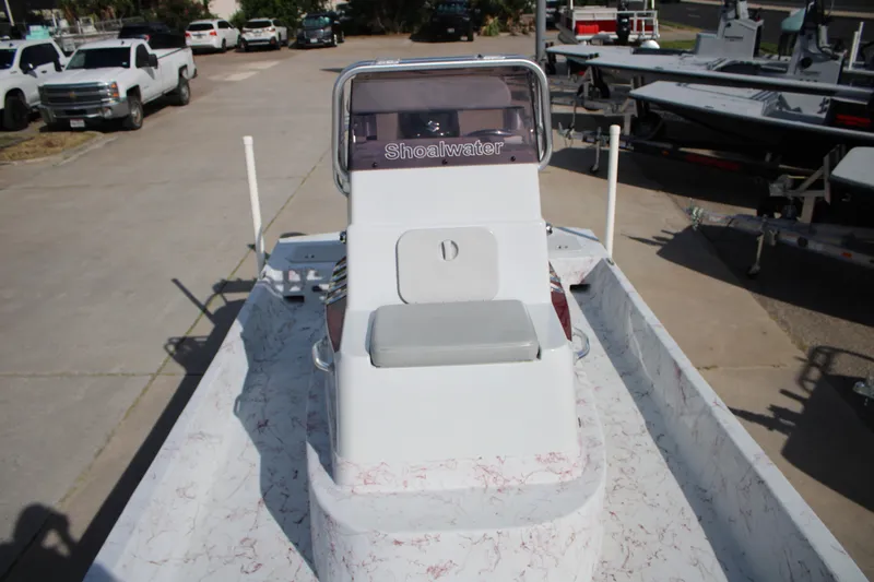 Slide: The Image of 2022 Shoalwater 20' Catamaran boat with center console, parked in a lot. - 6