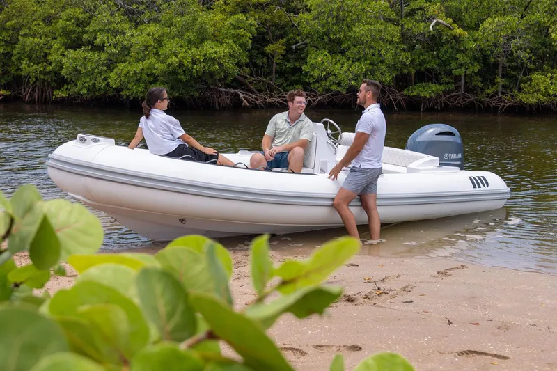 The Image of Manufacturer Provided Image: Novurania Como 18 boat at shore with three people, 2026 model. - 0