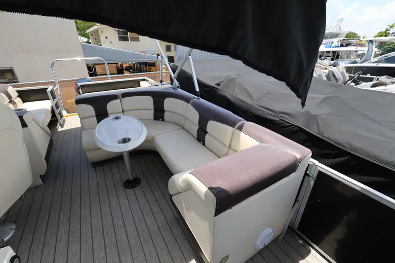 Slide: The Image of Luxurious seating area on a 2021 Lexington 525 Series 5 boat with a small table. - 13