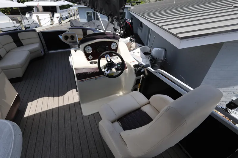 Slide: The Image of 2021 Lexington 525 Series 5 boat interior with steering console and seating. - 21