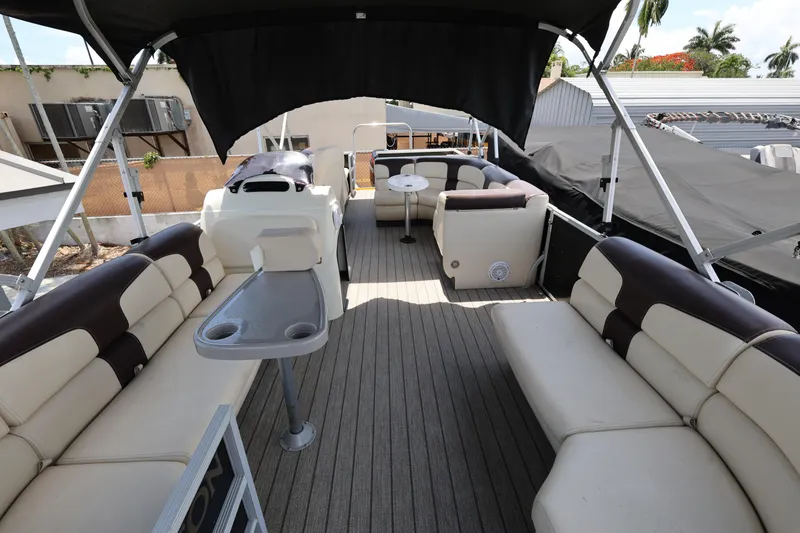 Slide: The Image of Luxurious 2021 Lexington 525 Series 5 pontoon boat interior with spacious seating and canopy. - 10