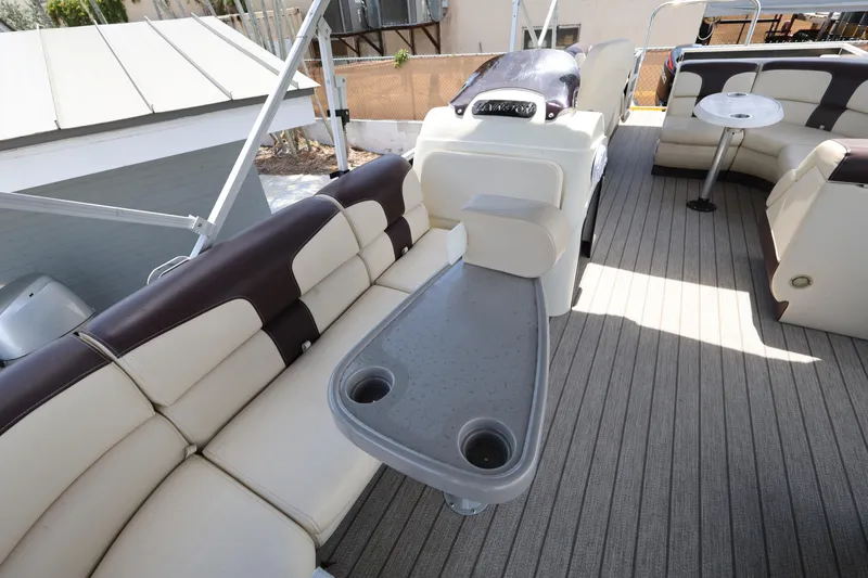 Slide: The Image of Luxurious 2021 Lexington 525 Series 5 pontoon boat interior with plush seating and table. - 12