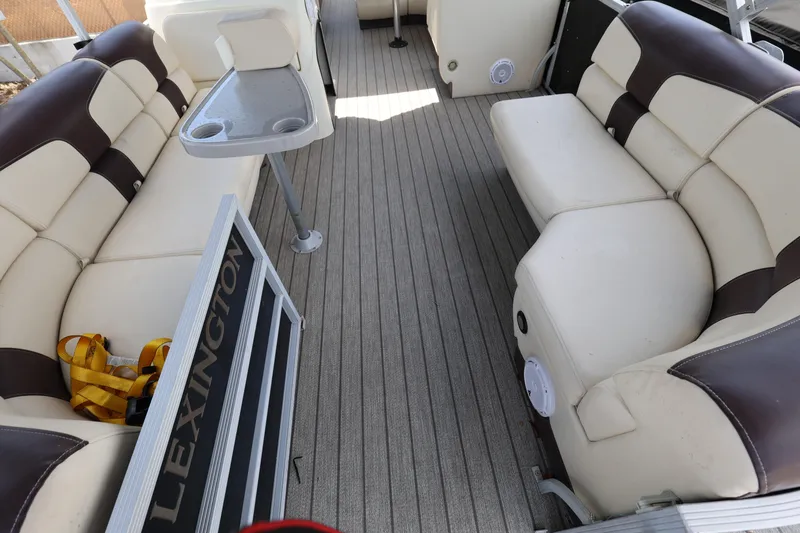 Slide: The Image of Luxurious seating on a 2021 Lexington 525 Series 5 boat with beige and brown upholstery. - 9
