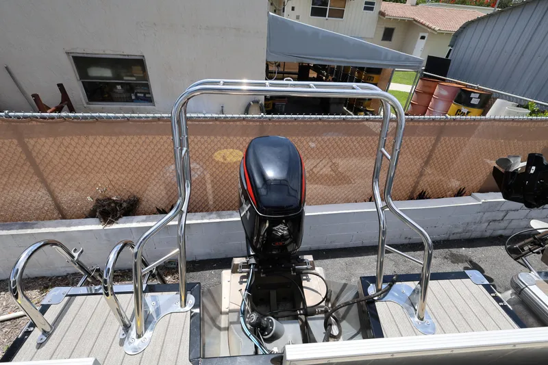 Slide: The Image of 2021 Lexington 525 Series 5 boat with outboard motor and stainless steel railings. - 19