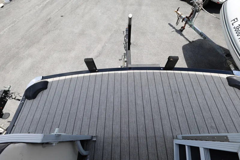 Slide: The Image of 2021 Lexington 525 Series 5 boat deck with trailer hitch, parked on asphalt. - 8