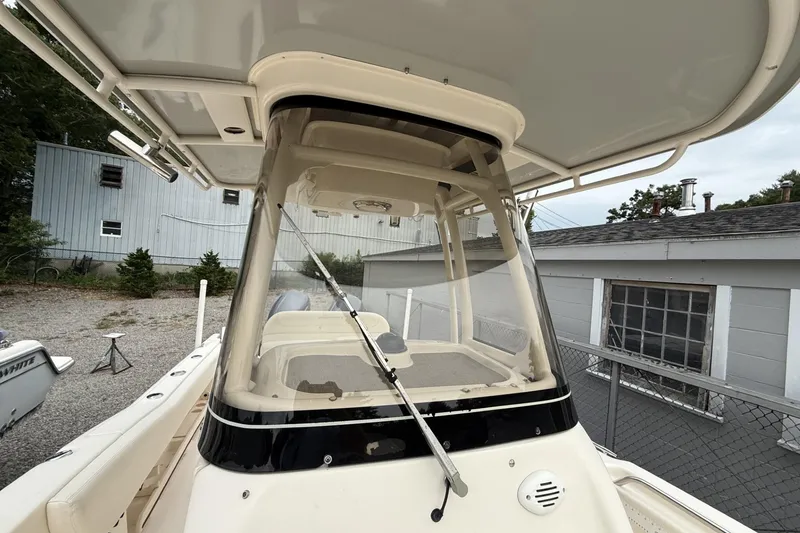 Slide: The Image of 2020 Grady-White Fisherman 257 boat with center console and T-top in a yard setting. - 24