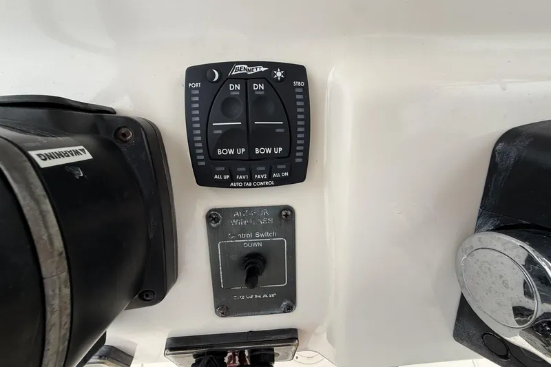 Slide: The Image of Control panel of a 2020 Grady-White Fisherman 257 boat with trim tab controls. - 26