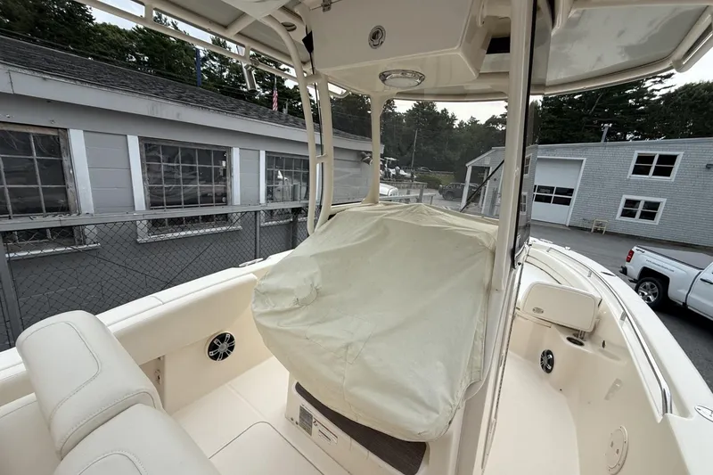 Slide: The Image of 2020 Grady-White Fisherman 257 boat interior with covered console, docked near buildings. - 5