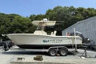 The Image of 2020 Grady-White Fisherman 257 boat on trailer, parked outdoors near trees and a building. - 1