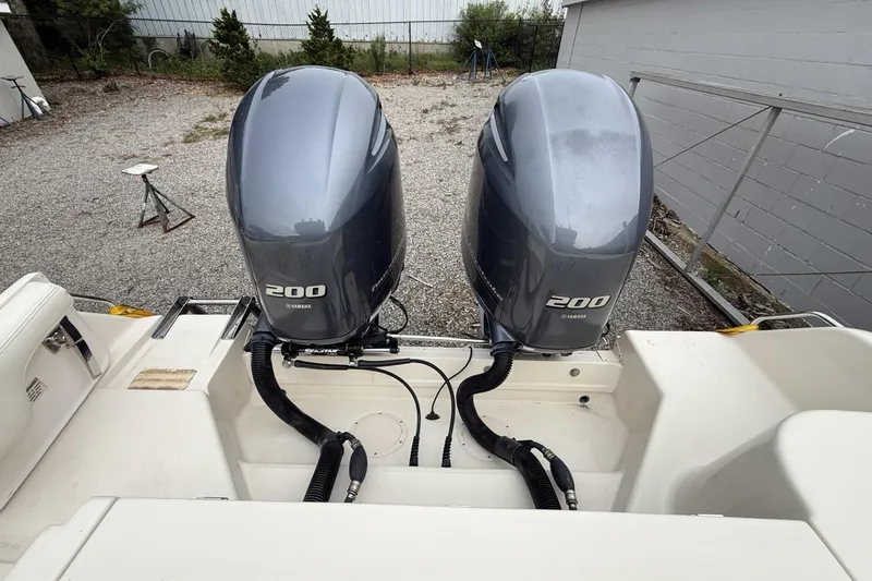 Slide: The Image of 2020 Grady-White Fisherman 257 with twin Yamaha 200 engines, parked on gravel. - 29