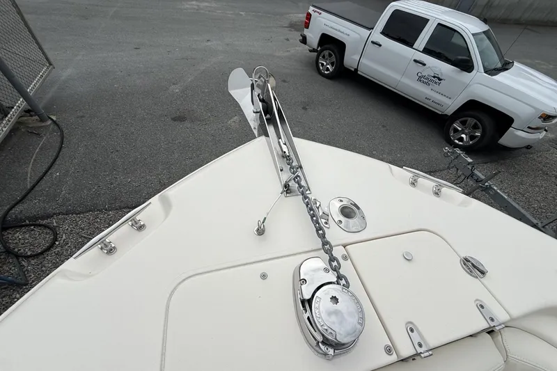 Slide: The Image of Bow of 2020 Grady-White Fisherman 257 with anchor chain, parked truck in background. - 9