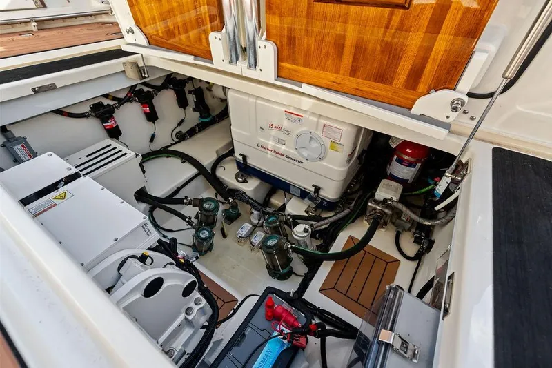 Slide: The Image of Engine compartment of 2024 Boston Whaler 405 Conquest, showcasing generator and mechanical systems. - 67