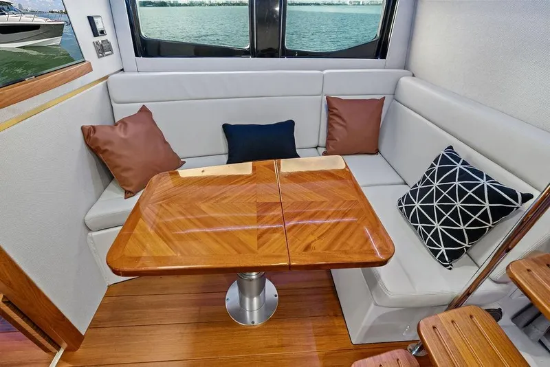 Slide: The Image of Interior of 2024 Boston Whaler 405 Conquest with elegant seating and wooden table. - 53