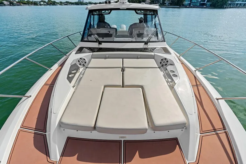 Slide: The Image of 2024 Boston Whaler 405 Conquest boat with spacious deck and luxurious seating on water. - 22