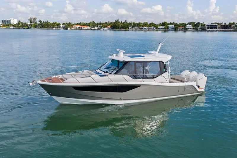 Slide: The Image of 2024 Boston Whaler 405 Conquest cruising on calm waters under a clear sky. - 3