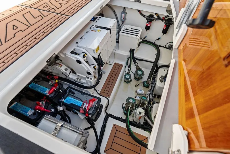 Slide: The Image of Engine compartment of 2024 Boston Whaler 405 Conquest, showcasing batteries and mechanical components. - 65