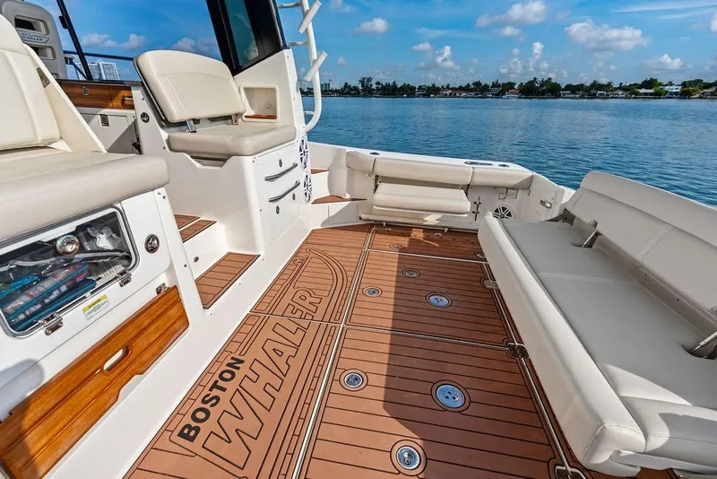 Slide: The Image of 2024 Boston Whaler 405 Conquest boat interior with luxurious seating and teak flooring. - 43