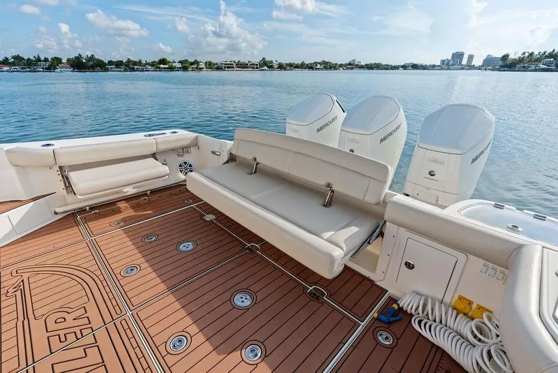 Slide: The Image of 2024 Boston Whaler 405 Conquest boat deck with seating and Mercury engines. - 42