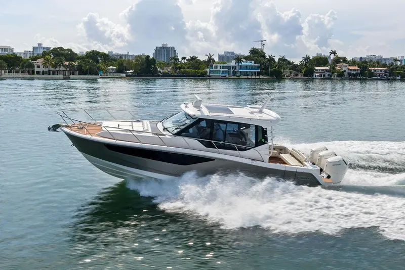 Slide: The Image of 2024 Boston Whaler 405 Conquest cruising on a scenic waterway. - 19