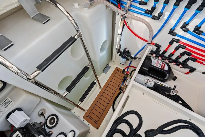 Slide: The Image of Engine room of 2024 Boston Whaler 405 Conquest with ladder and organized piping system. - 69