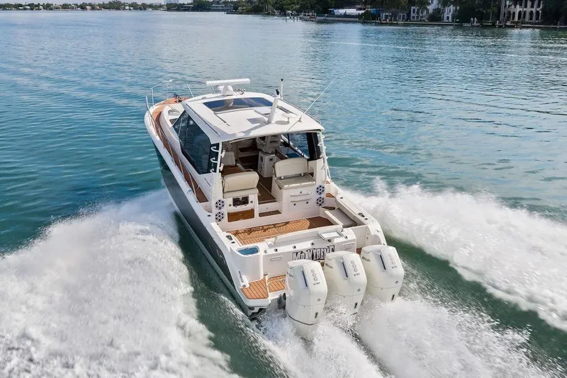 Slide: The Image of 2024 Boston Whaler 405 Conquest cruising on calm waters, showcasing powerful engines and sleek design. - 17