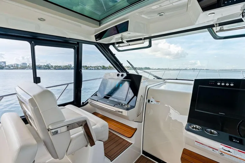 Slide: The Image of Interior view of 2024 Boston Whaler 405 Conquest helm with modern navigation equipment. - 27