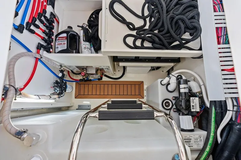 Slide: The Image of Engine compartment of 2024 Boston Whaler 405 Conquest with cables and maintenance equipment. - 68