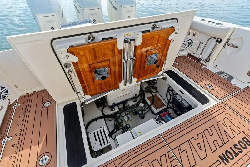 Slide: The Image of 2024 Boston Whaler 405 Conquest engine compartment with open hatch, showcasing detailed interior components. - 66