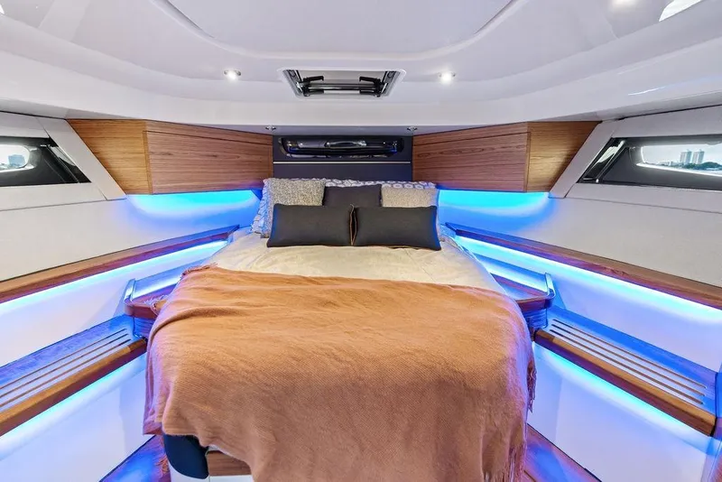Slide: The Image of Luxurious cabin interior of 2024 Boston Whaler 405 Conquest with ambient lighting and cozy bedding. - 59