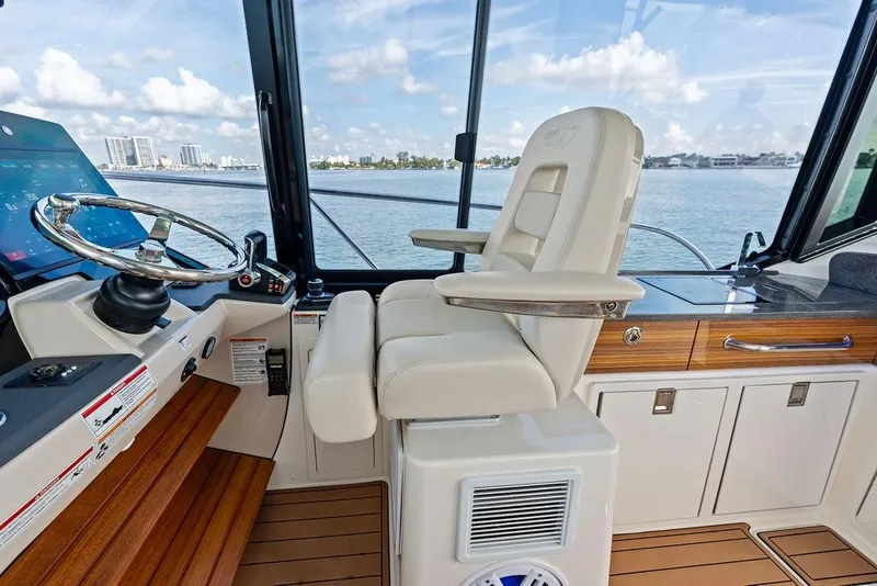 Slide: The Image of 2024 Boston Whaler 405 Conquest helm with luxurious seating and modern controls. - 33