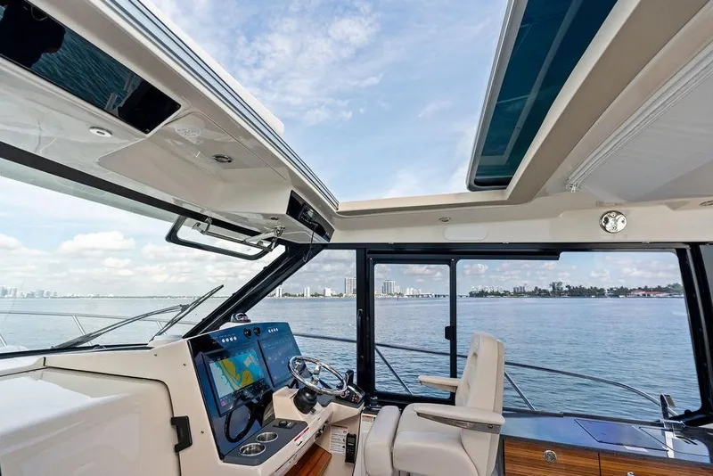 Slide: The Image of Interior view of 2024 Boston Whaler 405 Conquest helm with ocean backdrop. - 31