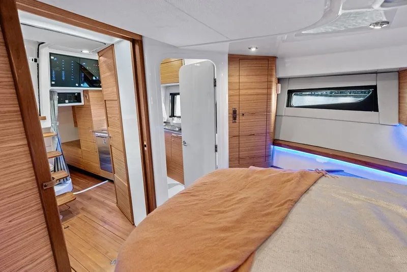 Slide: The Image of Luxurious interior of 2024 Boston Whaler 405 Conquest, featuring modern wood finishes and ambient lighting. - 61