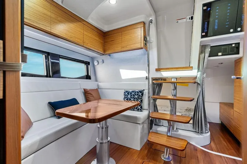 Slide: The Image of Luxurious interior of 2024 Boston Whaler 405 Conquest with modern seating and wooden accents. - 55