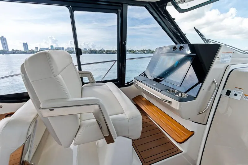 Slide: The Image of 2024 Boston Whaler 405 Conquest helm with luxurious seating and advanced navigation system. - 28