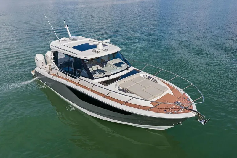 Slide: The Image of 2024 Boston Whaler 405 Conquest cruising on calm waters, showcasing sleek design and luxury features. - 13