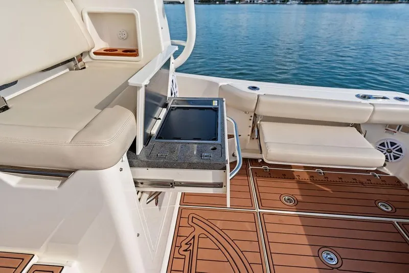 Slide: The Image of 2024 Boston Whaler 405 Conquest boat deck with seating and storage, overlooking water. - 44
