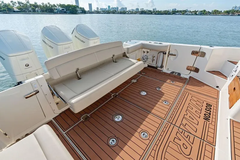 Slide: The Image of 2024 Boston Whaler 405 Conquest boat deck with seating and Mercury engines. - 40