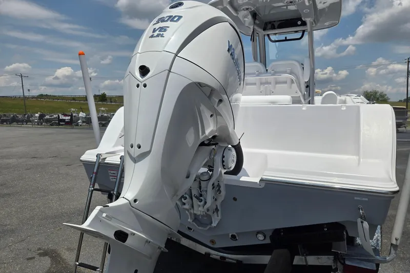 Slide: The Image of 2026 Sportsman Open 232 Center Console boat with powerful outboard motor in a sunny outdoor setting. - 3